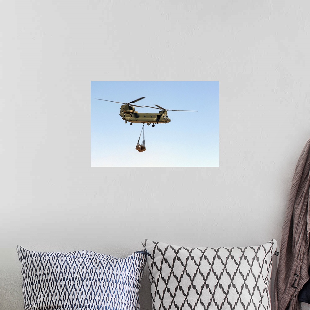 A bohemian room featuring A CH-47 Chinook of the Royal Air Force transports a sling load of pallets.