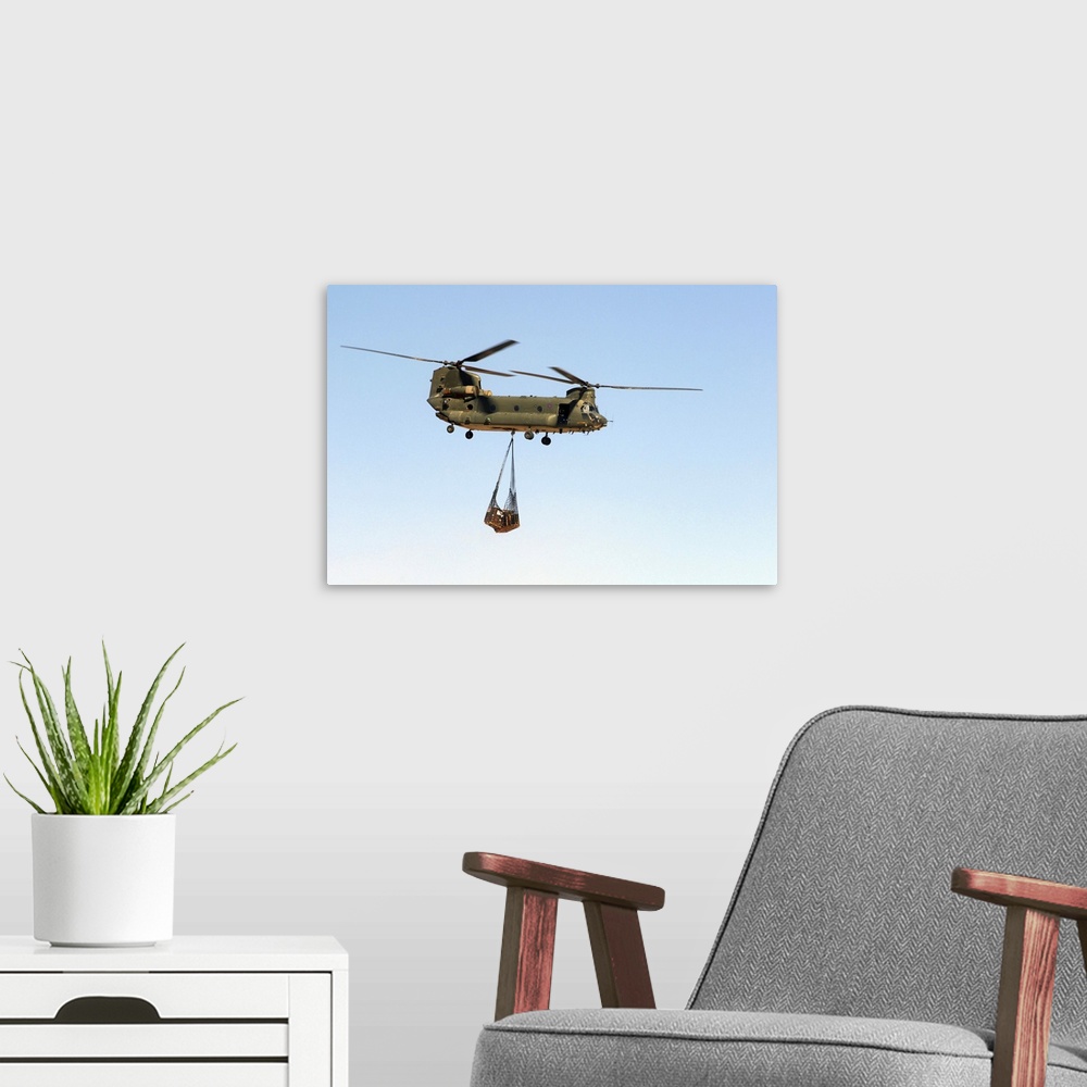 A modern room featuring A CH-47 Chinook of the Royal Air Force transports a sling load of pallets.