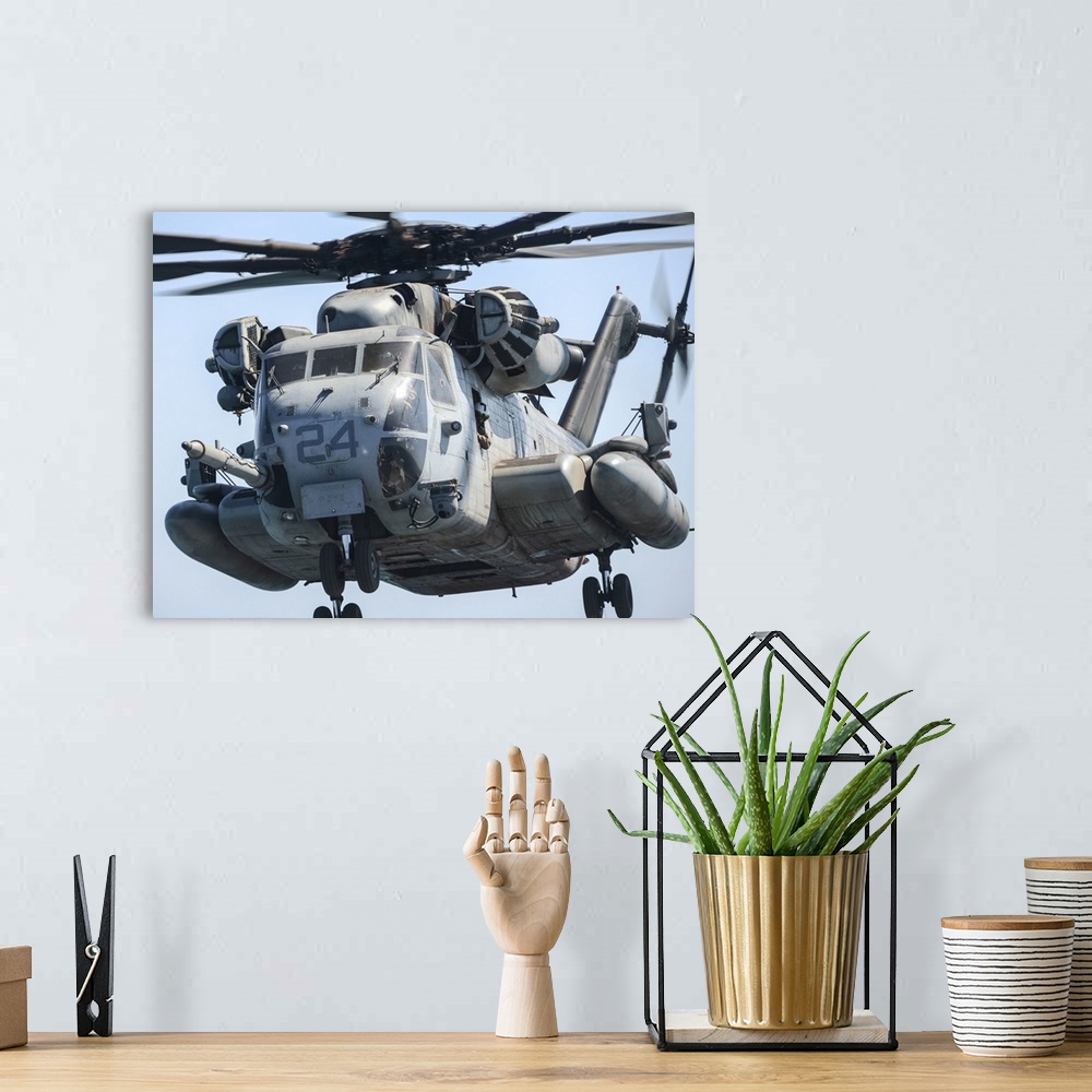 A bohemian room featuring A CH-53 Super Stallion takes off from the flight deck of USS Green Bay.