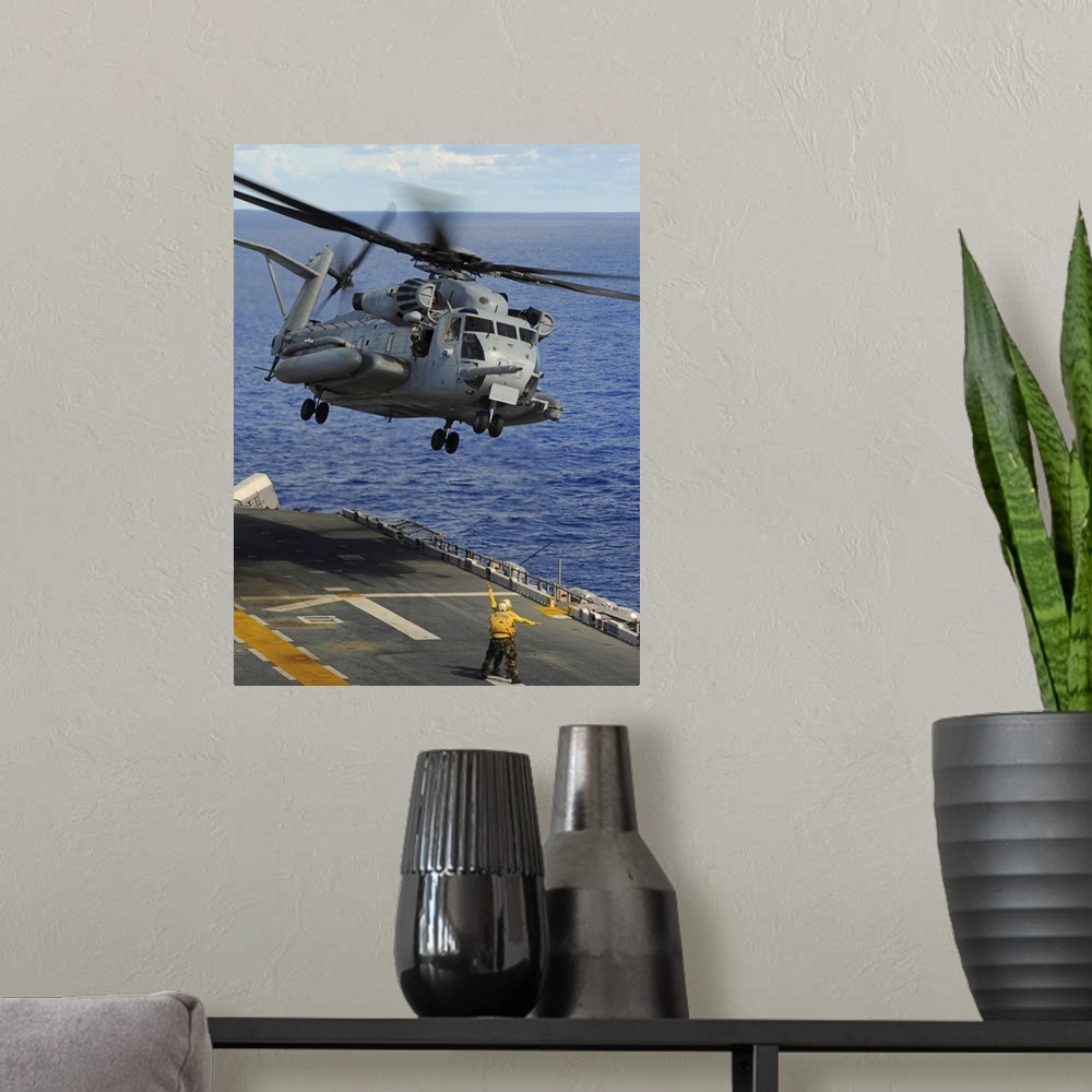 A modern room featuring Philippine Sea, September 14, 2010 - A CH-53E Sea Stallion helicopter takes off from the forward-...