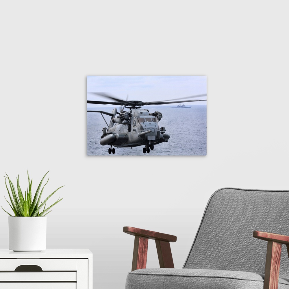 A modern room featuring Atlantic Ocean, February 14, 2013 - A CH-53E Super Stallion conducts flight operations near the g...