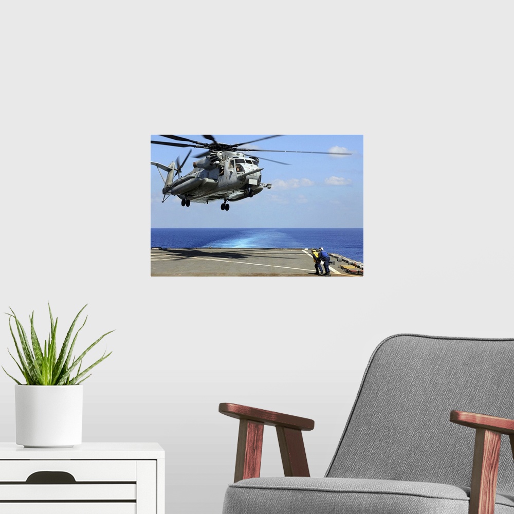 A modern room featuring Indian Ocean, March 26, 2011 - A CH-53E Super Stallion helicopter lifts off from the amphibious d...