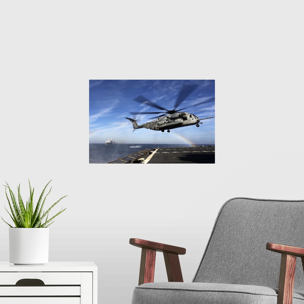 A modern room featuring December 7, 2011 - A CH-53E Super Stallion prepares to land on the USNS Arctic during a simulated...