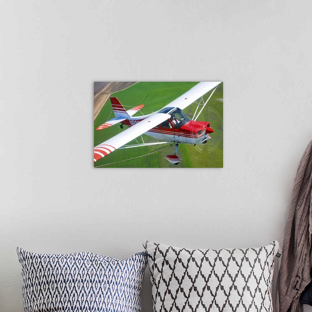 A bohemian room featuring A Champion Aircraft Citabria in flight near Hollister, California.