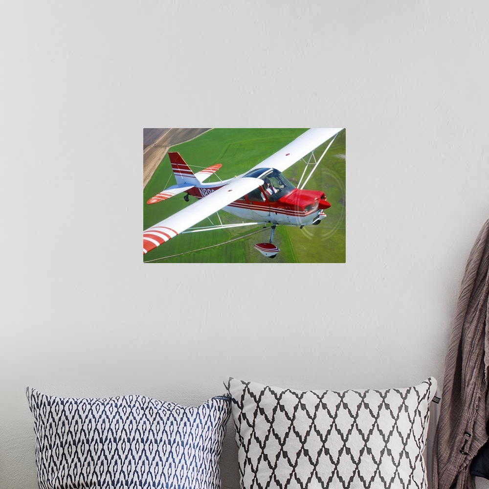 A bohemian room featuring A Champion Aircraft Citabria in flight near Hollister, California.
