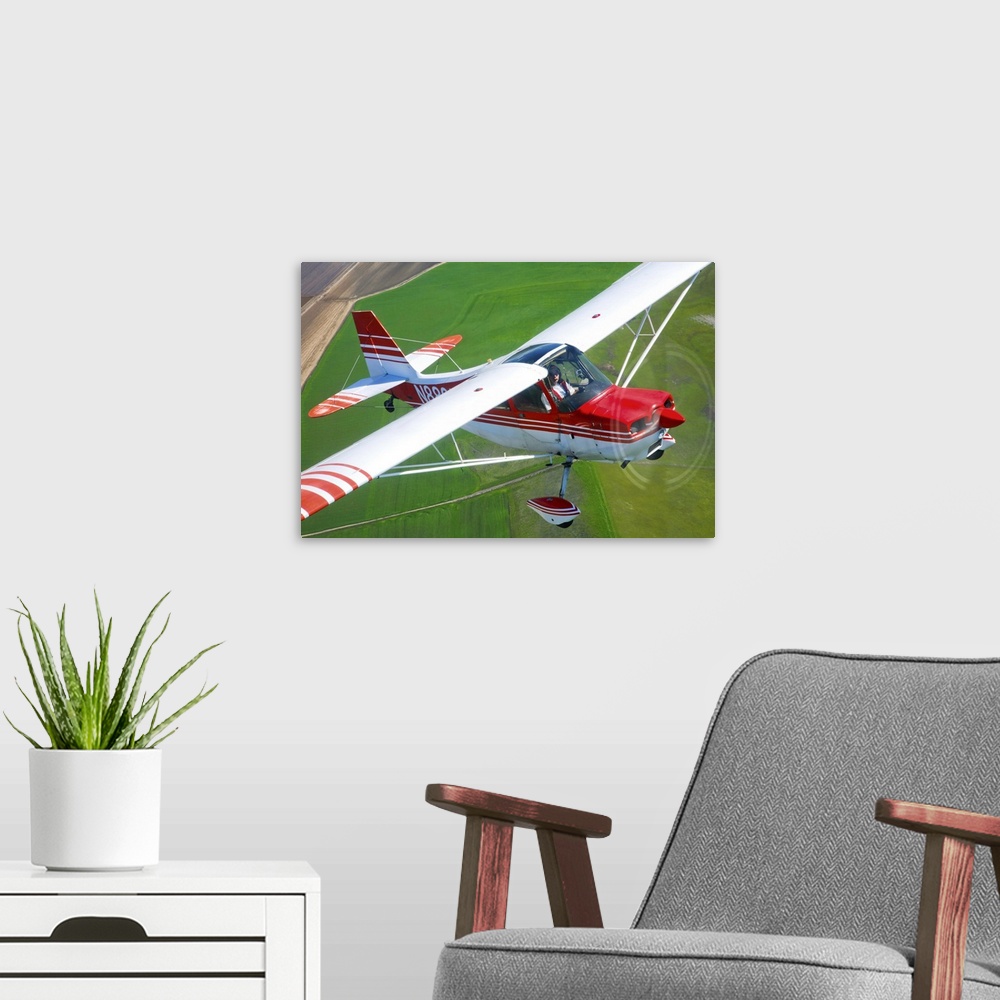 A modern room featuring A Champion Aircraft Citabria in flight near Hollister, California.