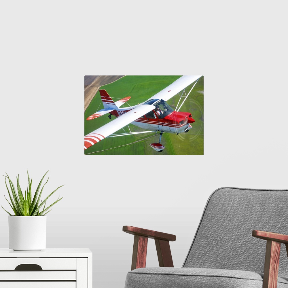 A modern room featuring A Champion Aircraft Citabria in flight near Hollister, California.