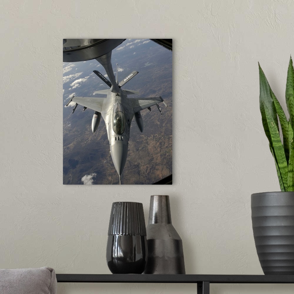 A modern room featuring A Chilean Air Force F-16 Fighting Falcon refuels from a U.S. Air Force KC-135 Stratotanker over B...