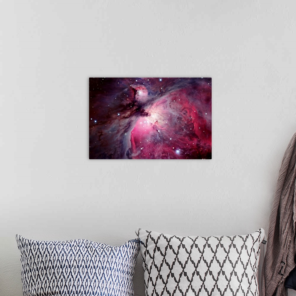 A bohemian room featuring Close shot of the Orion Nebula in outer space. Many shining stars visible.