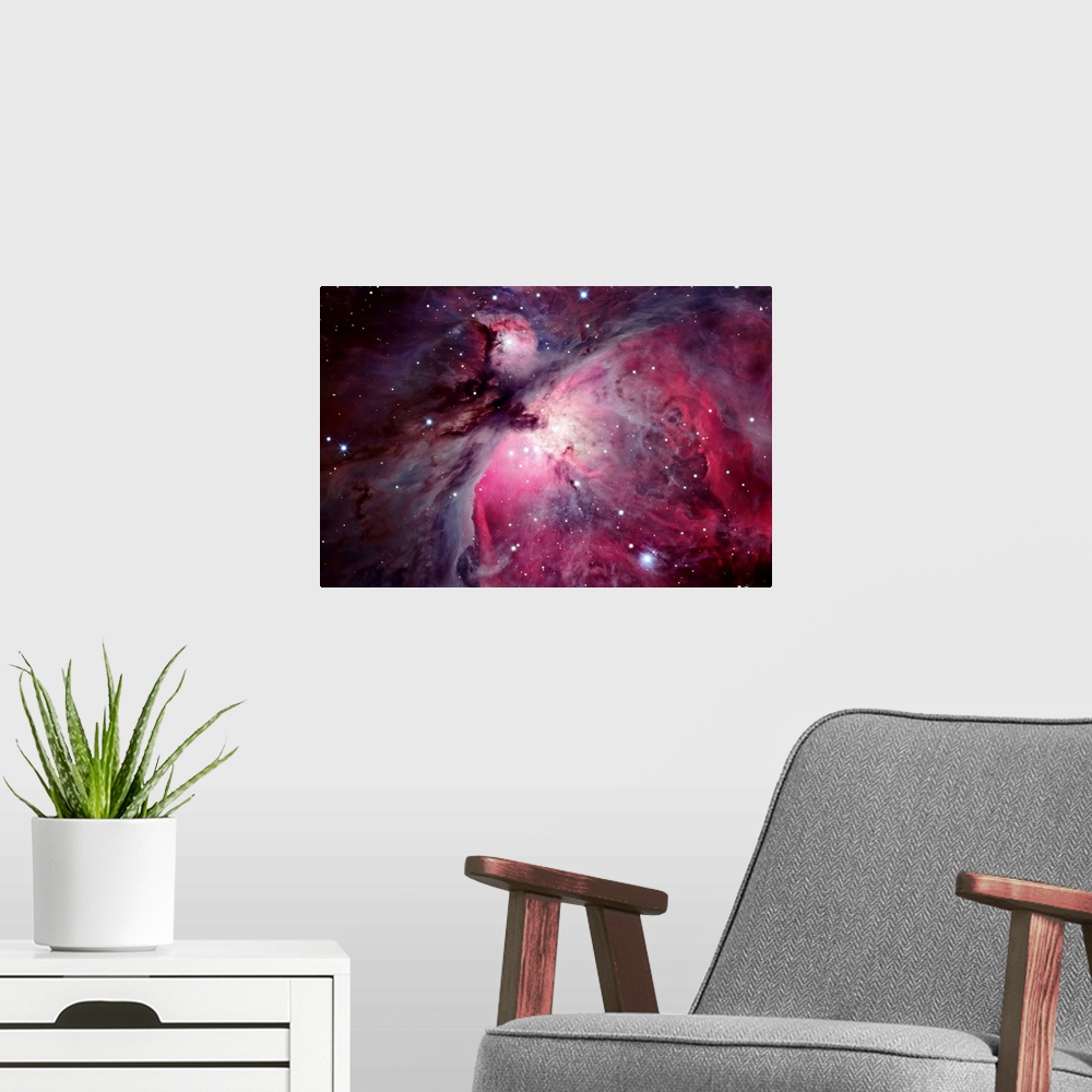 A modern room featuring Close shot of the Orion Nebula in outer space. Many shining stars visible.