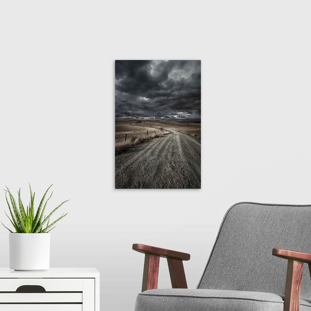 A modern room featuring A country road in field with stormy sky above, Tuscany, Italy.