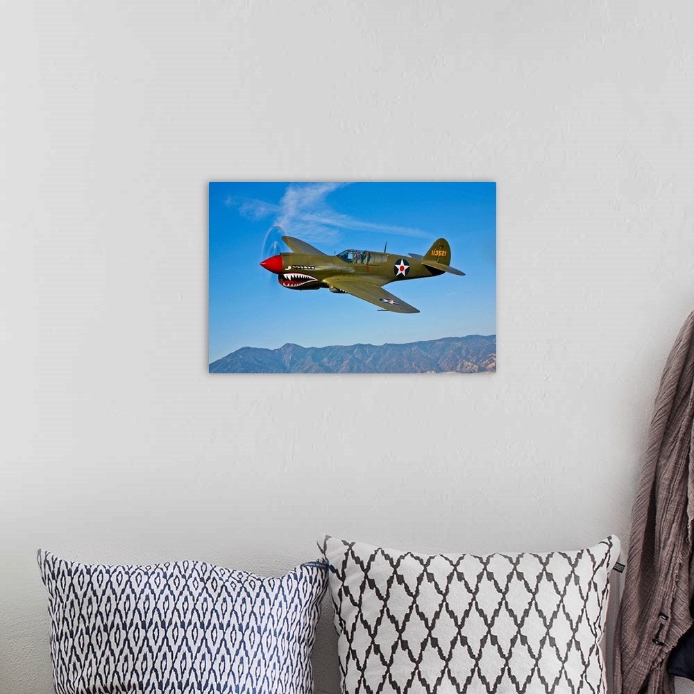 A bohemian room featuring A Curtiss P-40E Warhawk in flight near Chino, California.