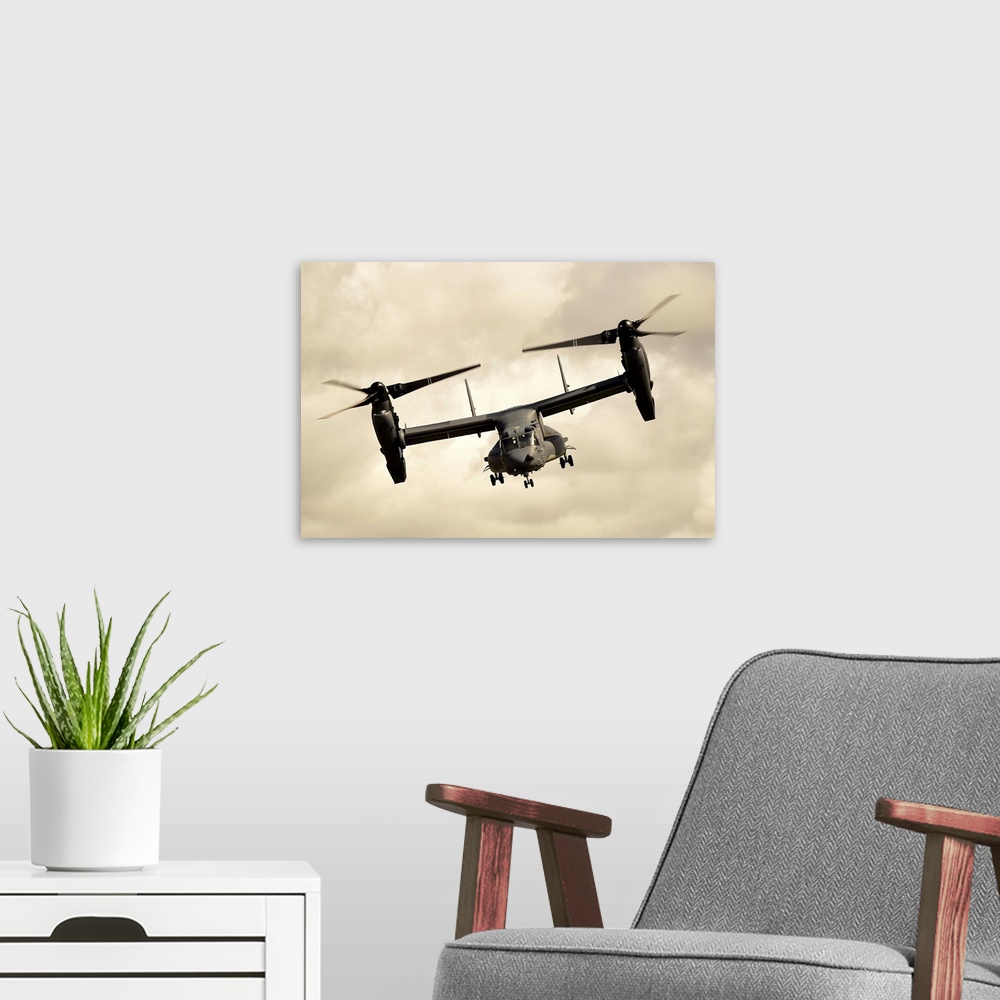 A modern room featuring A CV-22B Osprey performs an aerial display of its capabilities.