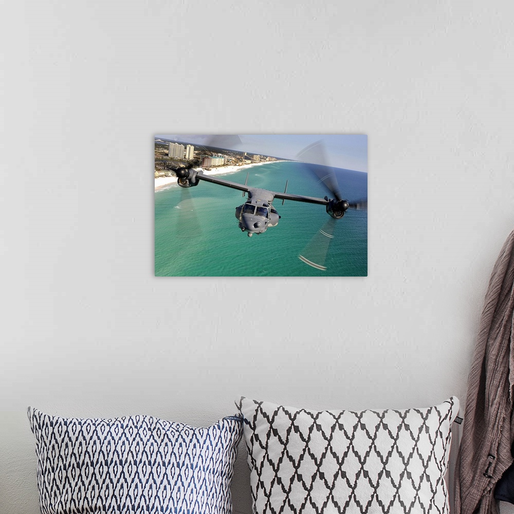 A bohemian room featuring Large landscape photograph of a CV22 Osprey aircraft flying toward the camera, over the green and...
