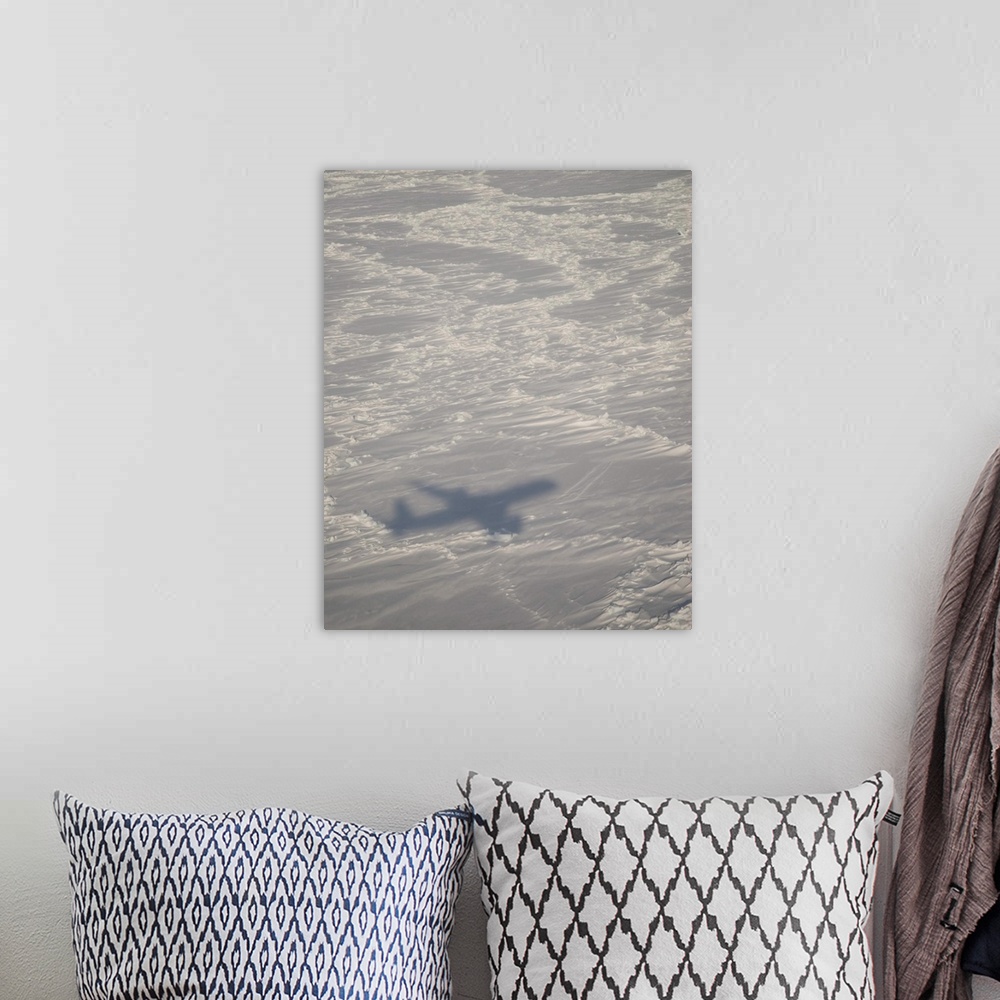 A bohemian room featuring A DC-8 aircraft casts its shadow over the Bering Sea.