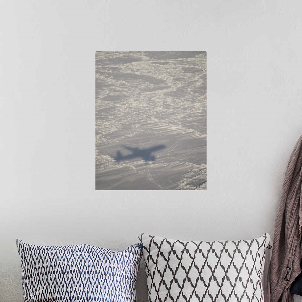A bohemian room featuring A DC-8 aircraft casts its shadow over the Bering Sea.