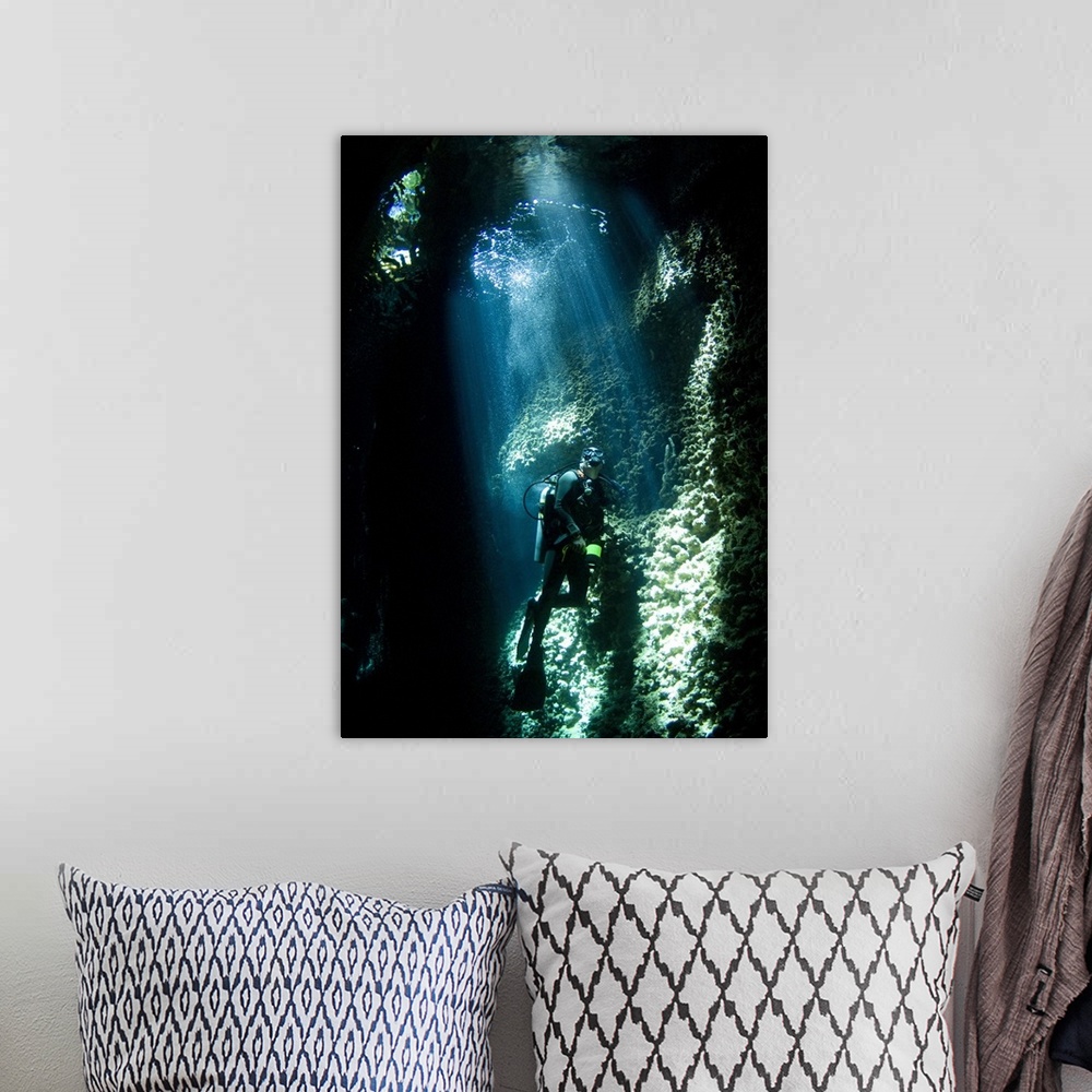 A bohemian room featuring A diver explores the Lerus Cut underwater cavern, Solomons.