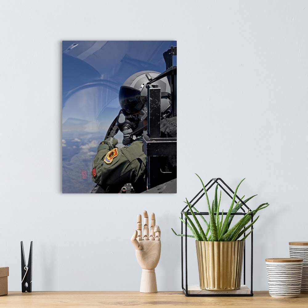 A bohemian room featuring A F-15 pilot from the 173rd Fighter Wing looks over at his wingman during a training mission over...