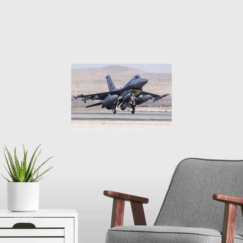 A modern room featuring A F-15E Strike Eagle of the U.S. Air Force uses aero braking after landing at Nellis Air Force Ba...