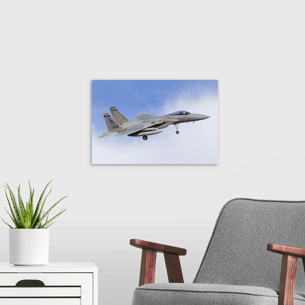 A modern room featuring A Florida Air National Guard F-15C Eagle turns to final approach at Nellis Air Force Base, Nevada.