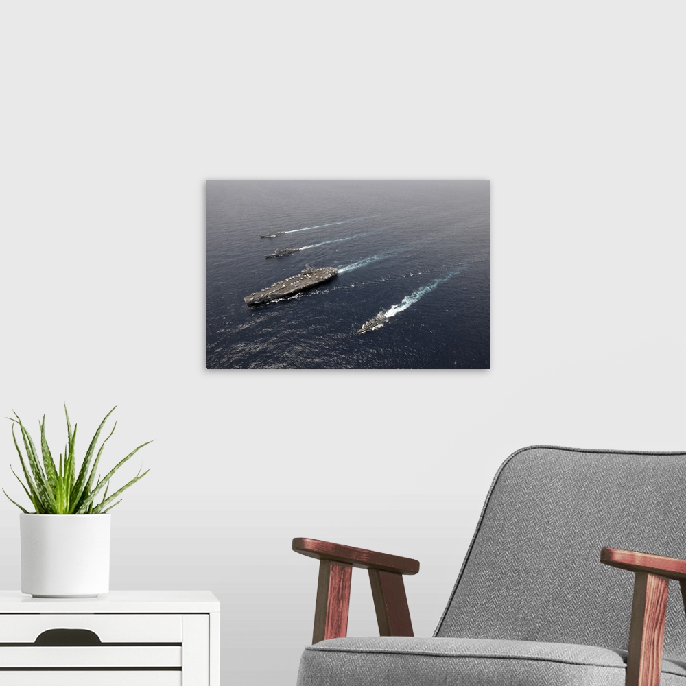 A modern room featuring A formation of ships traveling at sea.
