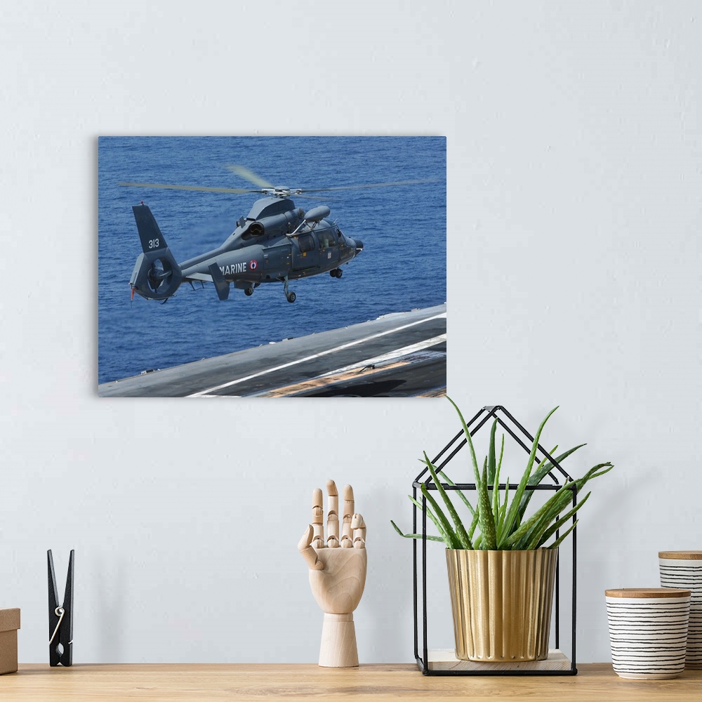 A bohemian room featuring A French Dolphin 35F helicopter takes off from the flight deck of USS John C. Stennis.