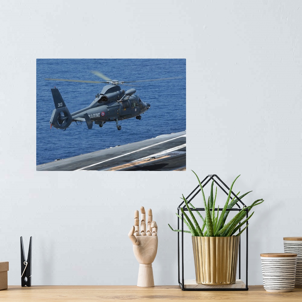 A bohemian room featuring A French Dolphin 35F helicopter takes off from the flight deck of USS John C. Stennis.