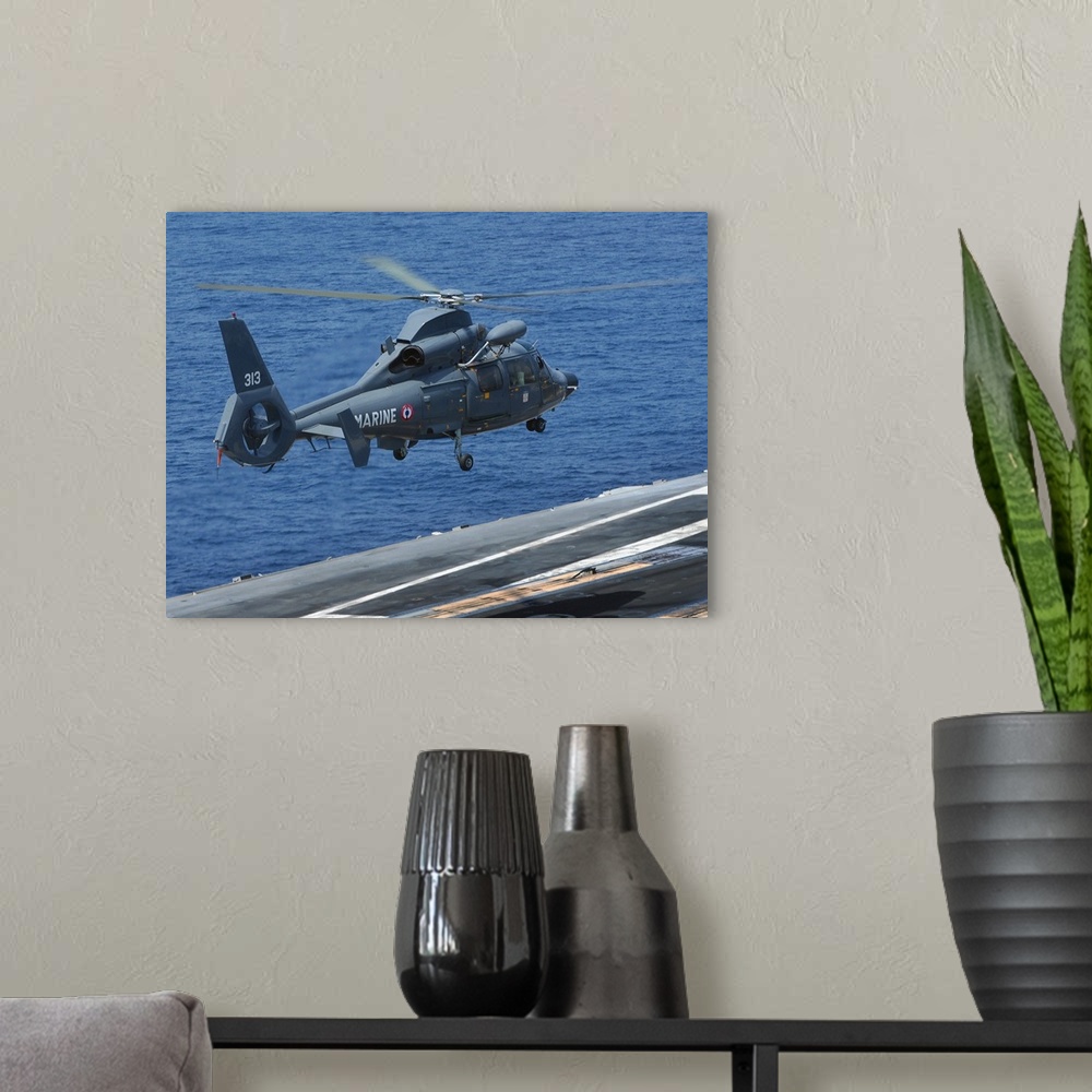 A modern room featuring A French Dolphin 35F helicopter takes off from the flight deck of USS John C. Stennis.