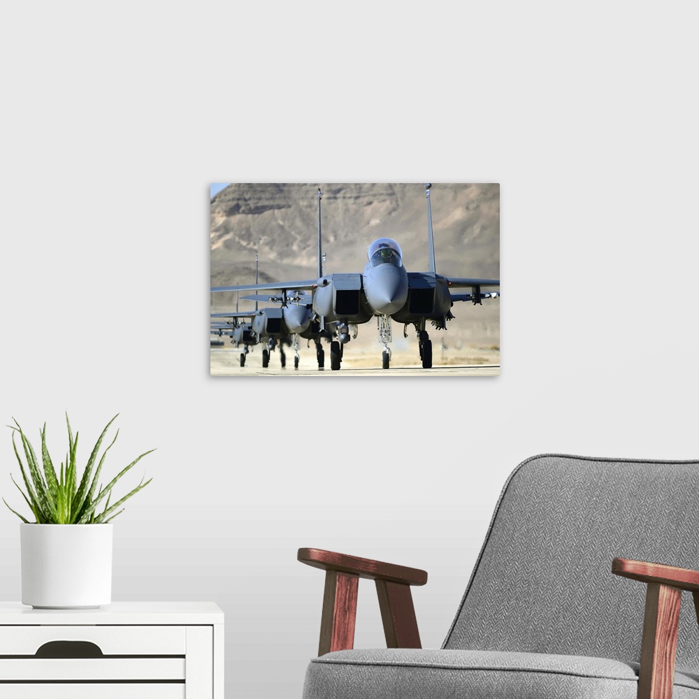 A modern room featuring November 26, 2013 - A group of F-15E Strike Eagles taxi following a combat mission during Blue Fl...