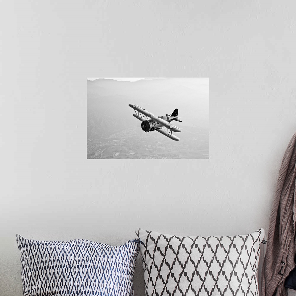 A bohemian room featuring A Grumman F3F biplane in flight.