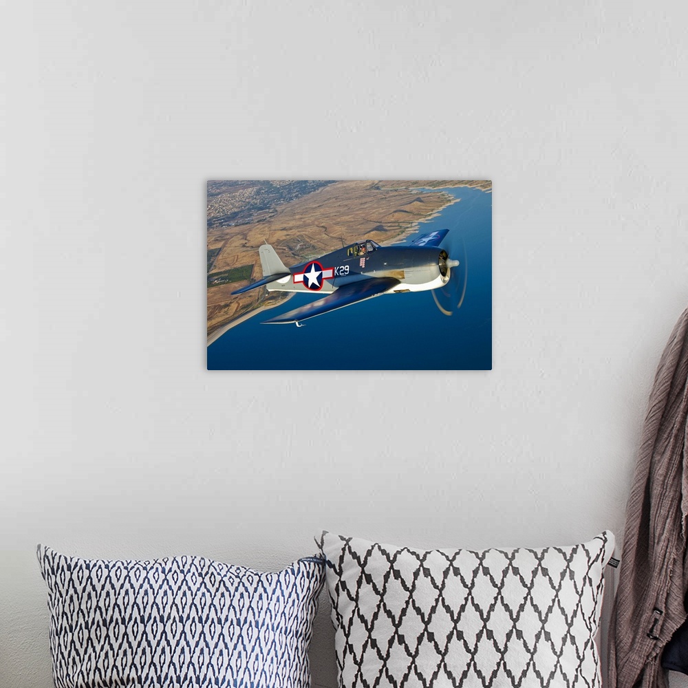 A bohemian room featuring A Grumman F6F Hellcat fighter plane in flight over Chino, California.