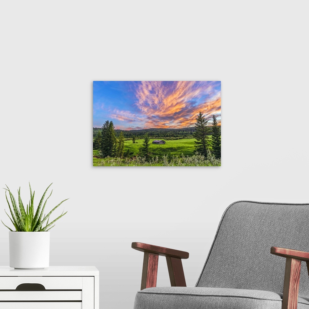 A modern room featuring July 9, 2014 - A high dynamic range photo of a sunset over a log cabin at Cypress Hills Interprov...