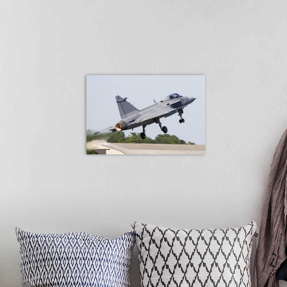 A bohemian room featuring A JAS-39 Gripen of the Swedish Air Force taking off.