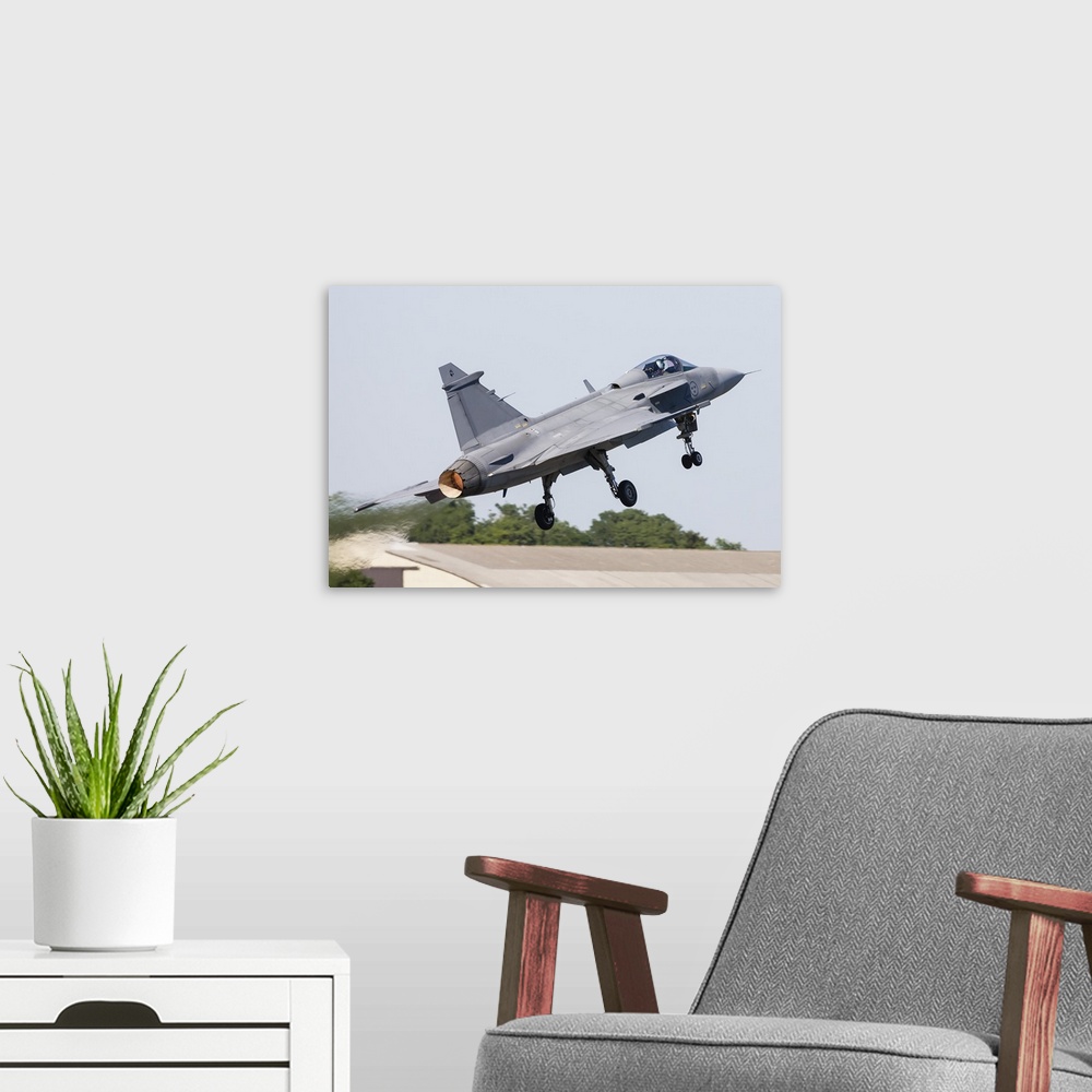 A modern room featuring A JAS-39 Gripen of the Swedish Air Force taking off.
