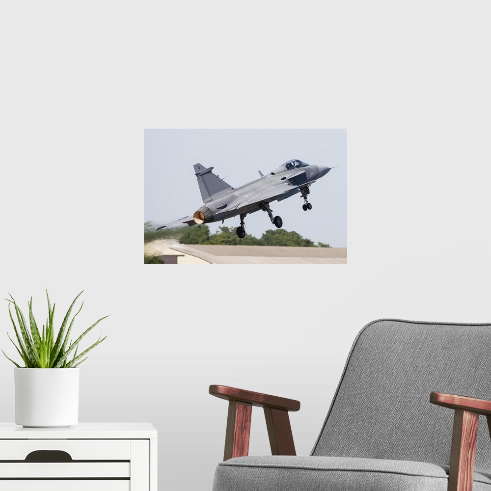A modern room featuring A JAS-39 Gripen of the Swedish Air Force taking off.