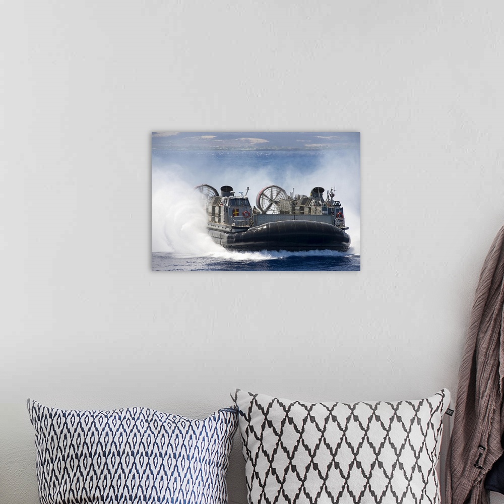 A bohemian room featuring Pacific Ocean, July 23, 2014 - A landing craft air cushion prepares to embark the well deck of th...