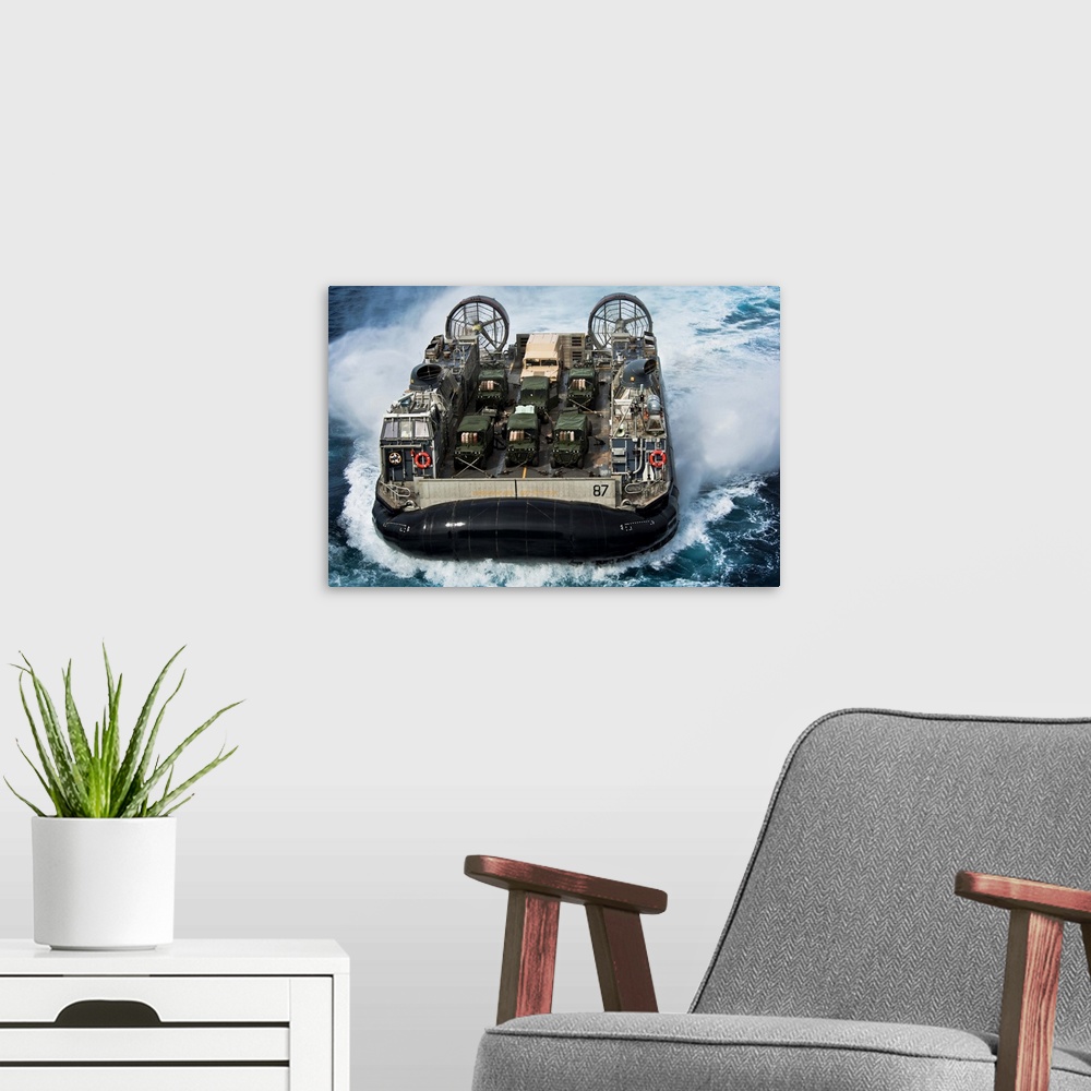 A modern room featuring Atlantic Ocean, April 10, 2012 - A landing craft air cushion (LCAC) approaches the well deck of t...