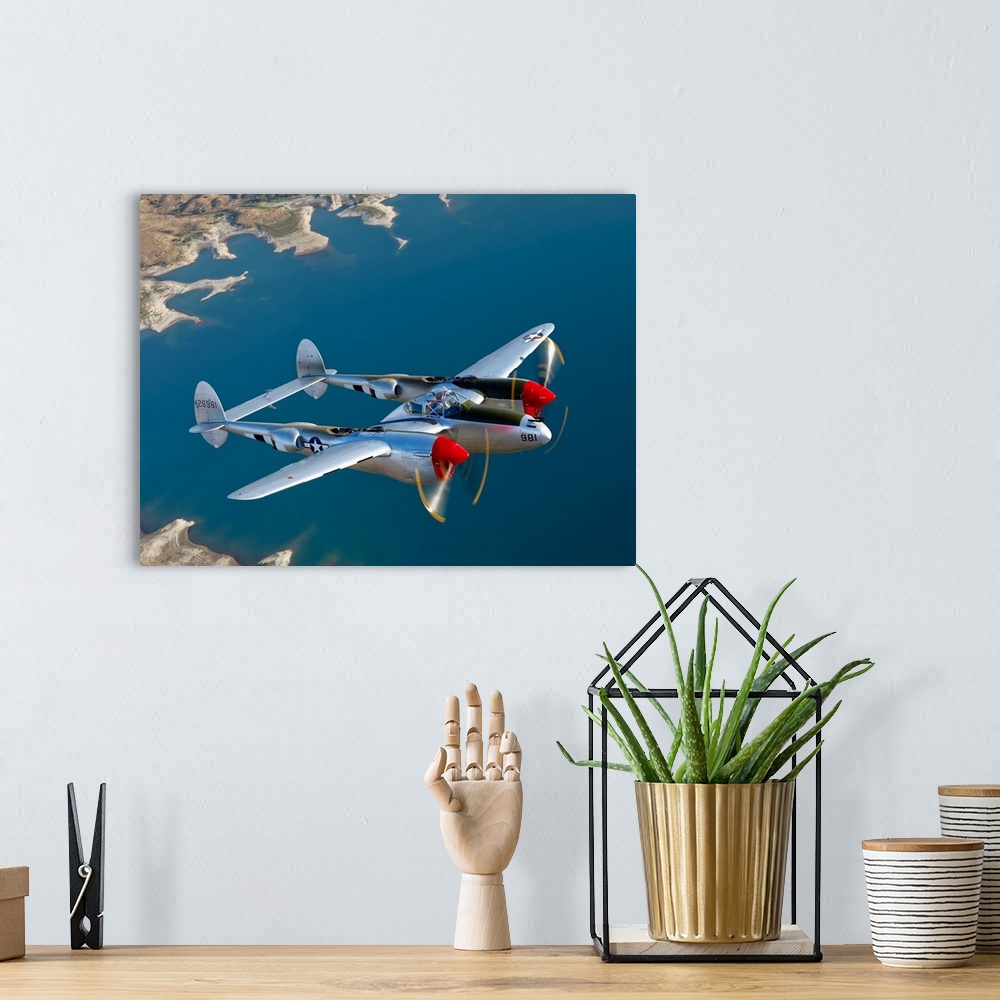 A bohemian room featuring Canvas photo art of a vintage airplane flying above water.