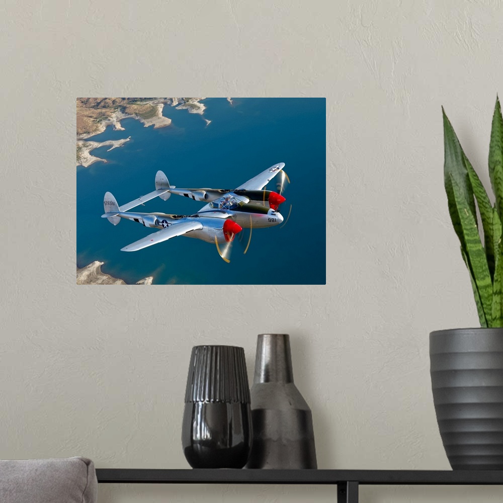 A modern room featuring Canvas photo art of a vintage airplane flying above water.