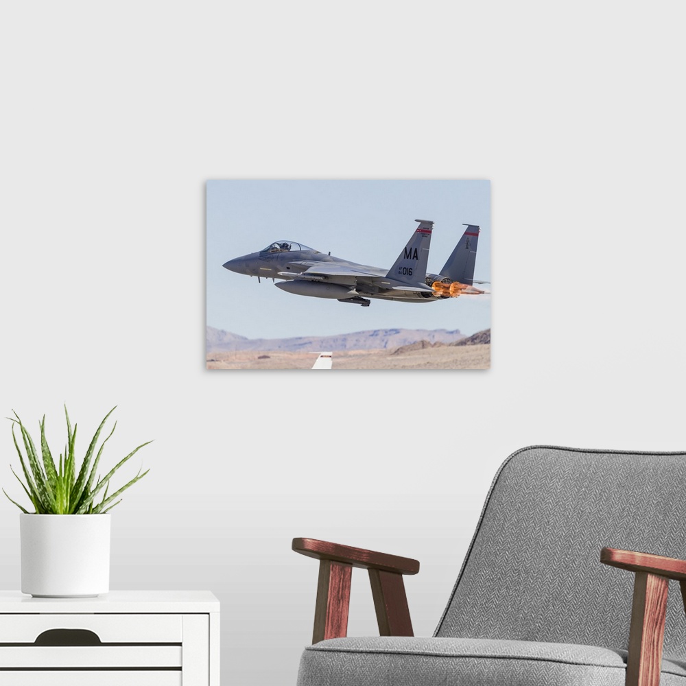 A modern room featuring A Massachusetts Air National Guard F-15C Eagle takes off from Nellis Air Force Base, Nevada, on a...