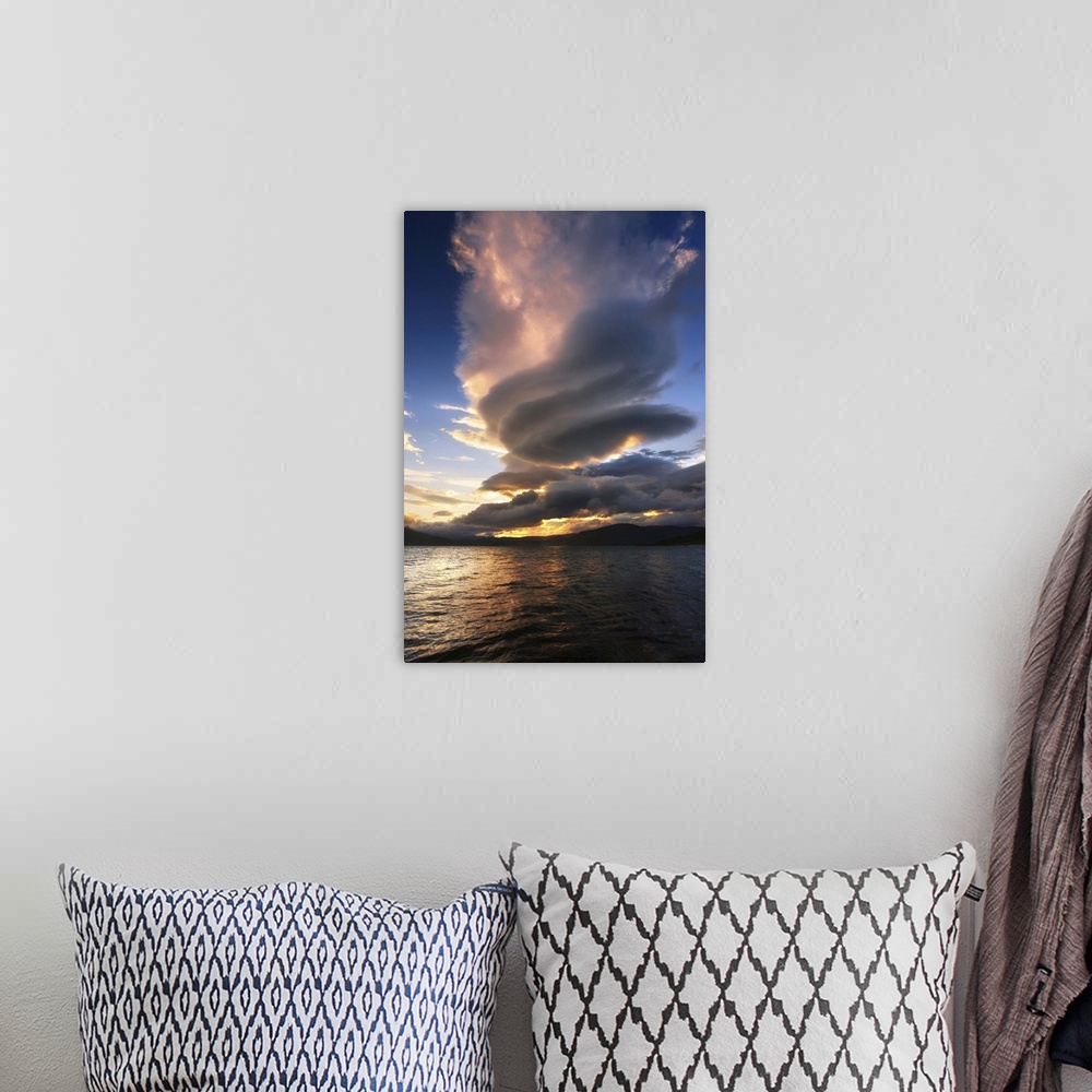 A bohemian room featuring A massive stacked lenticular cloud over Tjedsundet in Troms County, Norway.