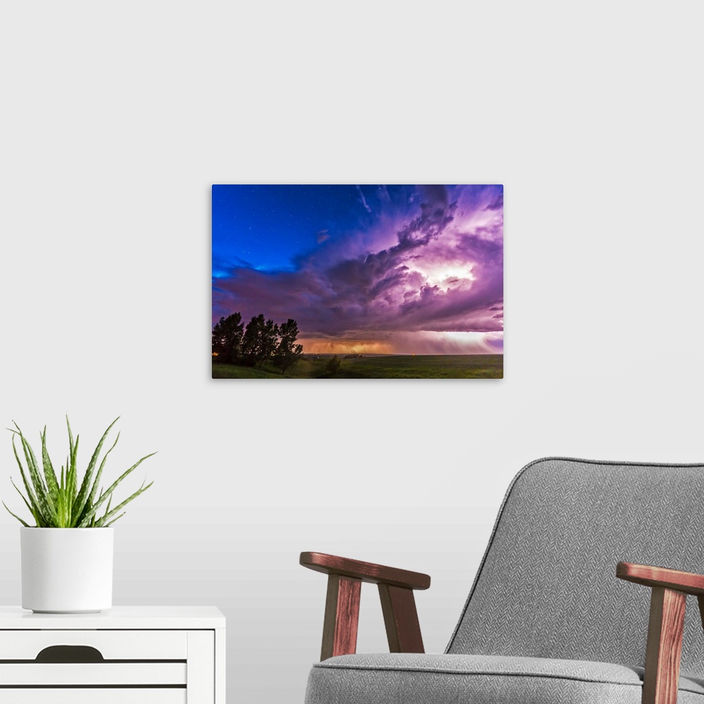 A modern room featuring June 20, 2014 - A massive thunderstorm moves across the northern horizon lit internally by lightn...