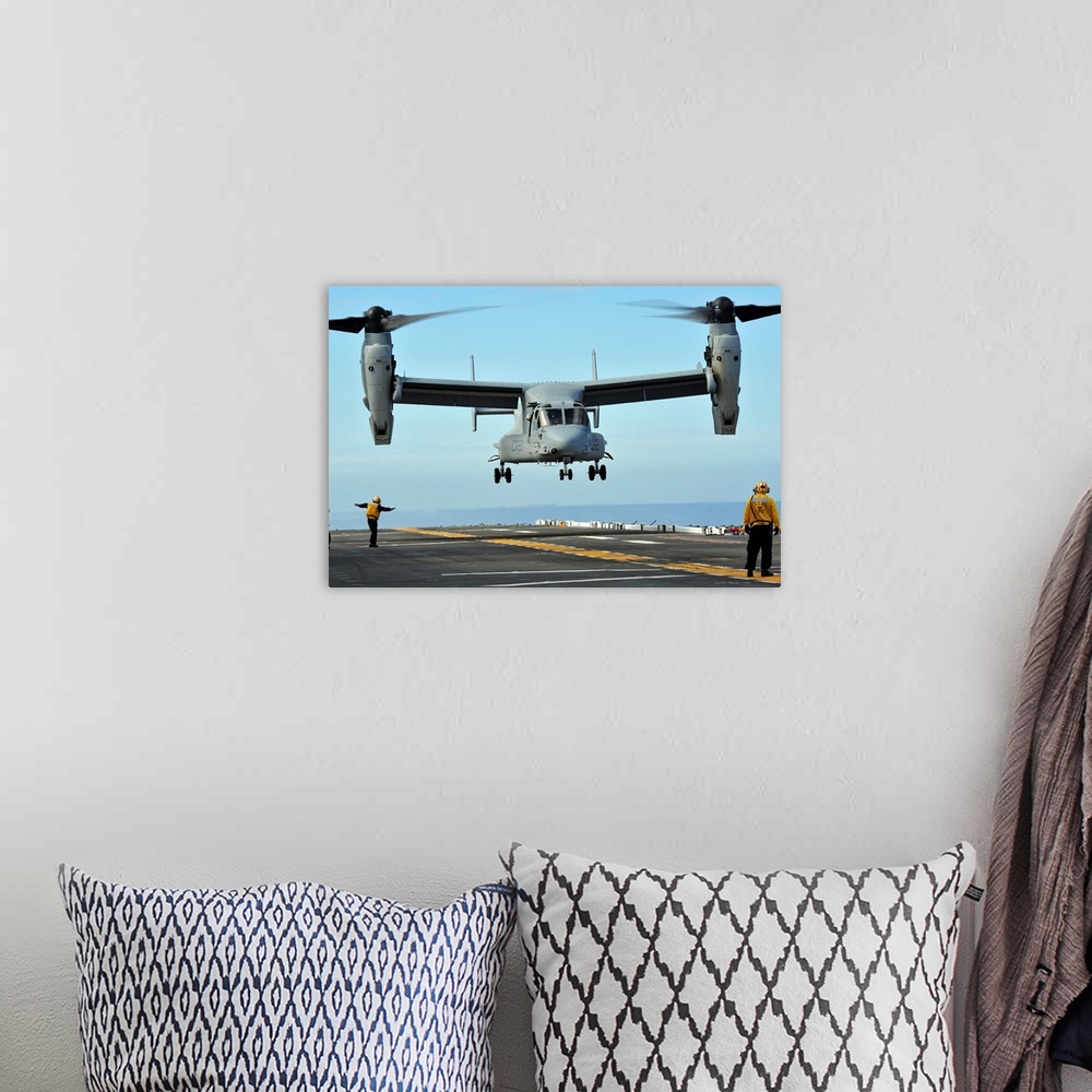 A bohemian room featuring March 1, 2011 - A U.S. Marine Corps MV-22 Osprey aircraft prepares to land on the flight deck of ...
