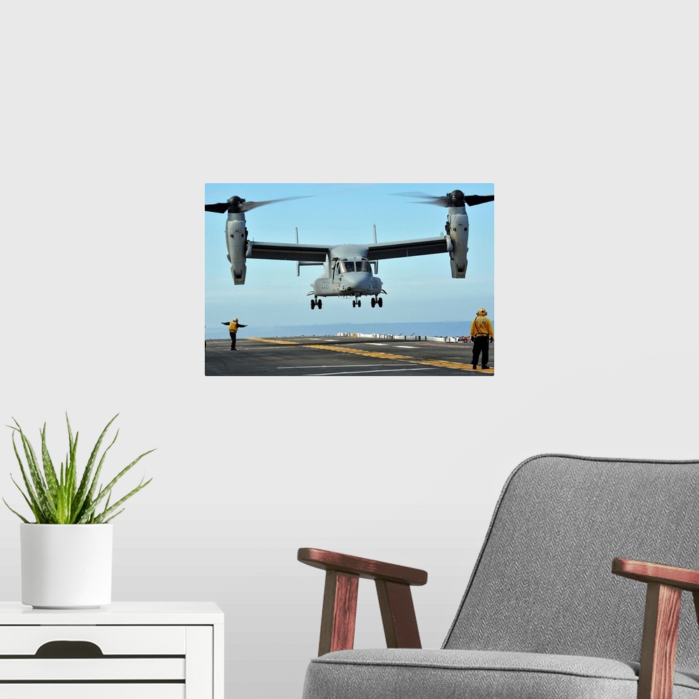 A modern room featuring March 1, 2011 - A U.S. Marine Corps MV-22 Osprey aircraft prepares to land on the flight deck of ...