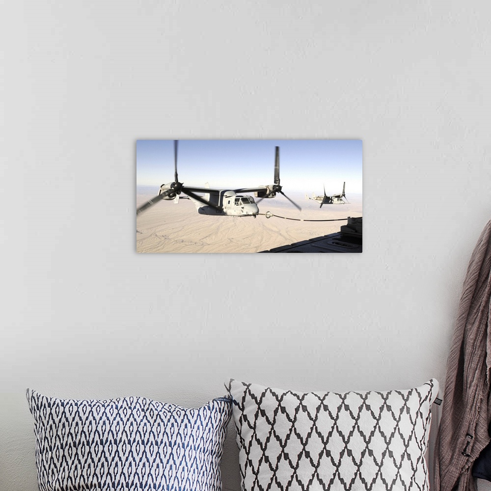 A bohemian room featuring A MV22 Osprey refuels midflight while another waits its turn