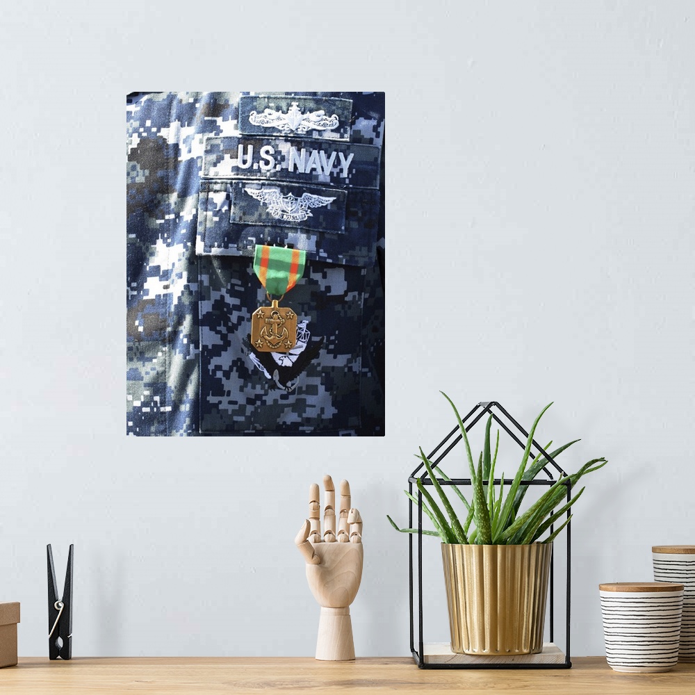 A bohemian room featuring A Navy and Marine Corps Achievement Medal adorns the U.S. Navy uniform.