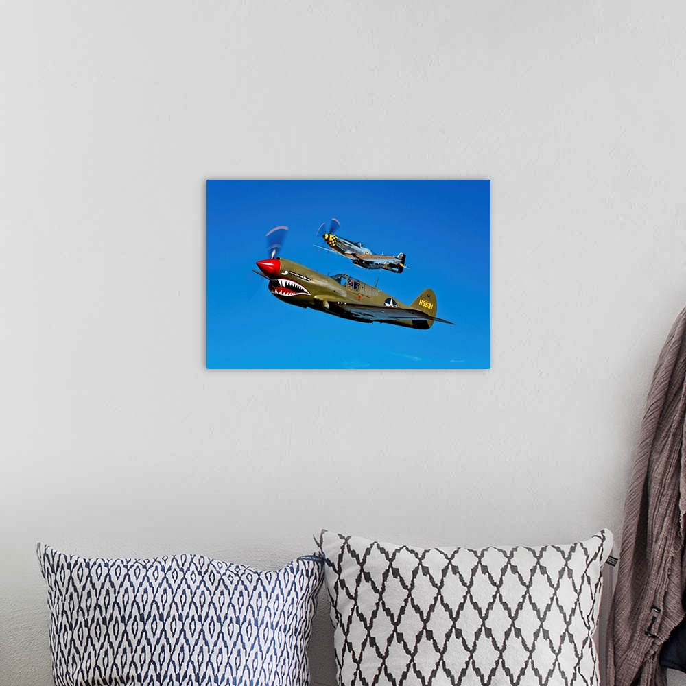 A bohemian room featuring A North American P-51D Mustang Kimberly Kaye and a Curtiss P-40E Warhawk in flight near Chino, Ca...