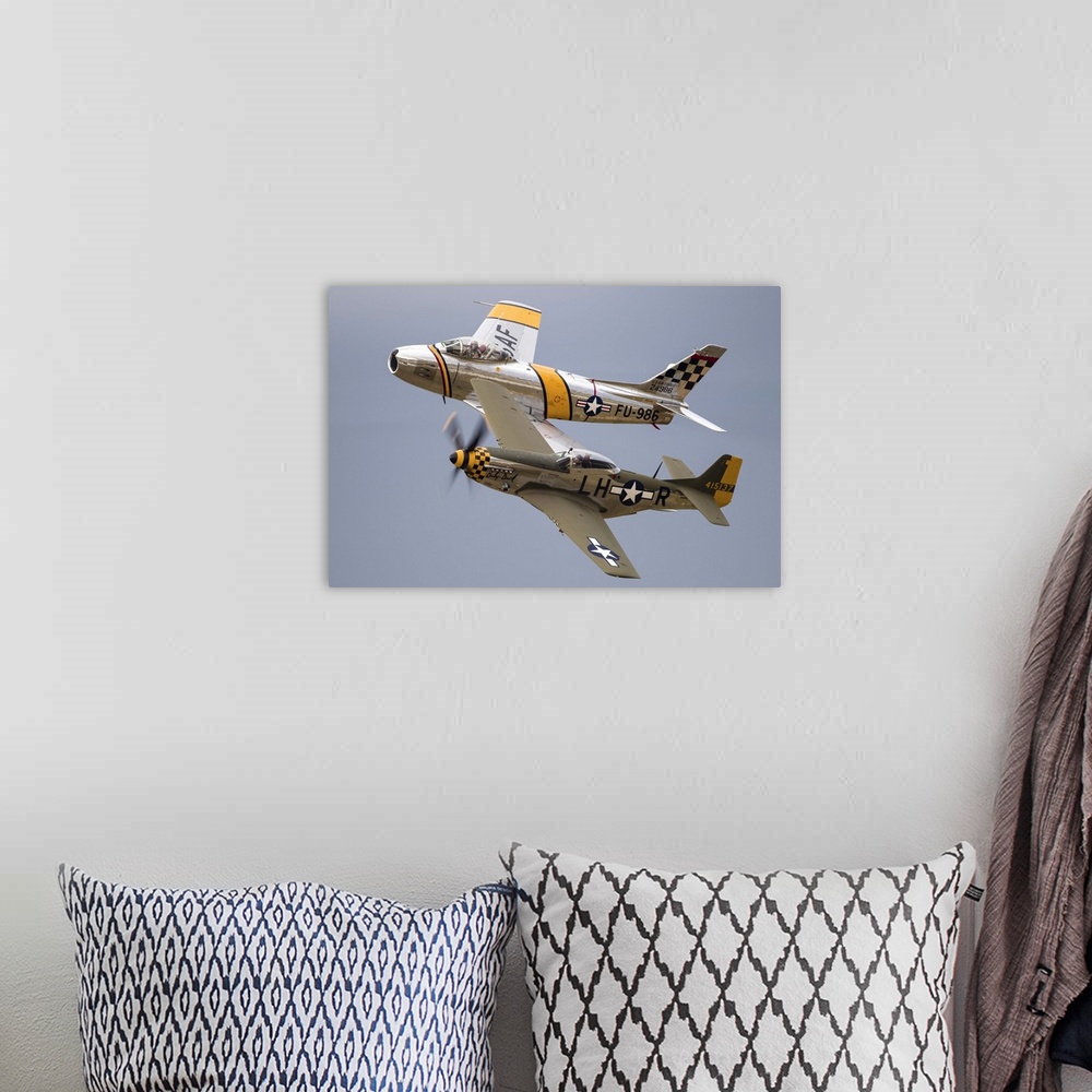 A bohemian room featuring A P-51 Mustang and F-86 Sabre of the Warbird Heritage Foundation carry out a heritage pass at Wau...