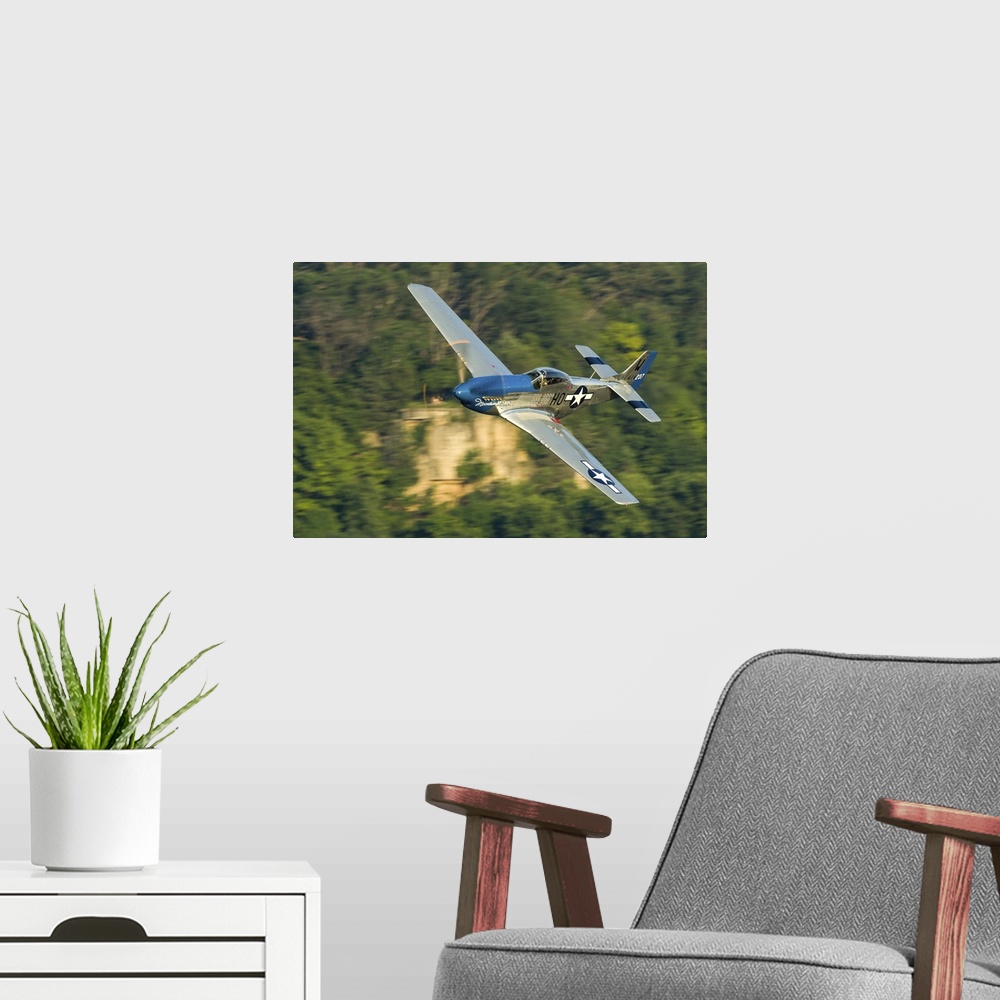 A modern room featuring A P-51 Mustang flies along the Mississippi at Dubuque, Iowa.