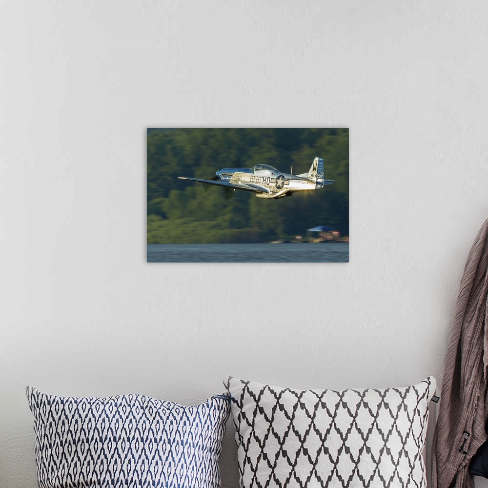 A bohemian room featuring A P-51 Mustang flies along the Mississippi at Dubuque, Iowa.